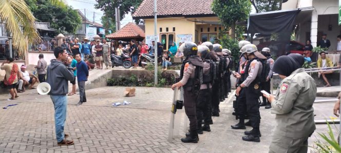 
 Foto : Aparat kepolisian Polres Lombok Timur Melakukan pengamanan terhadap aksi warga Dusun Jerian Desa Gereneng Kecamatan Sakra Timur yang merusak kantor desa menuntut Kapala Dusun diberhentikan